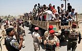 Iraqi men board military trucks to join the Iraqi army at the main recruiting center in Baghdad, Iraq, Saturday, June. 14, 2014, after authorities urged Iraqis to help battle insurgents. (Photo credit: AP/Karim Kadim)