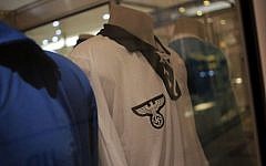 A Germany 1934 FIFA Soccer World Cup team jersey is displayed among other national soccer team jerseys on a shopping mall in Salvador, Brazil, Thursday, June 19, 2014. The Nazi eagle and swastika are clearly visible on the jersey's front. (photo credit: AP/Bernat Armangue)