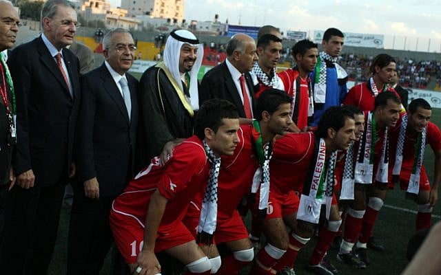 The Palestinian national team, with IOC president Jacques Rogge in Ramallah in 2010 before a friendly match against Jordan (photo credit: Issam Rimawi