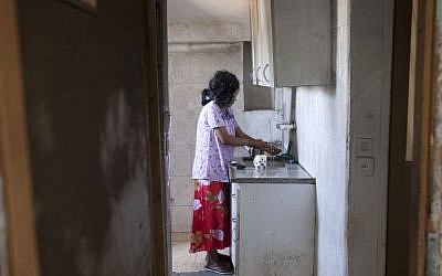 An African migrant from Eritrea is seen in her Jerusalem apartment after unknown attackers set it ablaze, June 2012. (photo credit: Yonatan Sindel/Flash90)