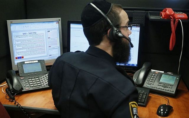 A policeman working in the emergency call center. The individual in this photo has no connection to this story. (illustrative photo: Miriam Alster/Flash90) A policeman working in the emergency call center. The individual in this photo has no connection to this story. (illustrative photo: Miriam Alster/Flash90)