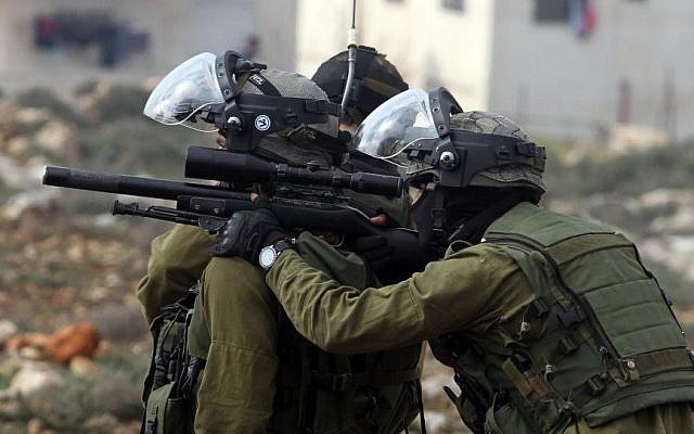 Soldiers are seen during a clash with Palestinian youths near the West Bank settlement of Beit El, February 2014. (illustrative photo credit: Issam Rimawi/Flash90) Soldiers are seen during a clash with Palestinian youths near the West Bank settlement of Beit El, February 2014. (illustrative photo credit: Issam Rimawi/Flash90)