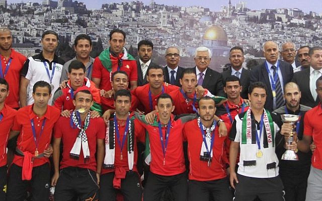 The Palestinian national soccer team along with PA President Mahmoud Abbas after winning the AFC Challenge Cup in late May 2014 (photo credit: Issam Rimawi/ Flash 90) The Palestinian national soccer team along with PA President Mahmoud Abbas after winning the AFC Challenge Cup in late May 2014 (photo credit: Issam Rimawi/ Flash 90)