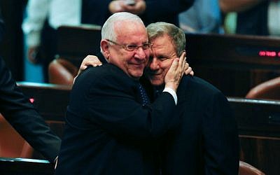 President-elect Reuven Rivlin and Hatnua MK Meir Sheetrit embrace in the Knesset plenum after MKs finished casting their votes in Israel's presidential elections, Tuesday, June 10, 2014. (photo credit: Yonatan Sindel/Flash90)