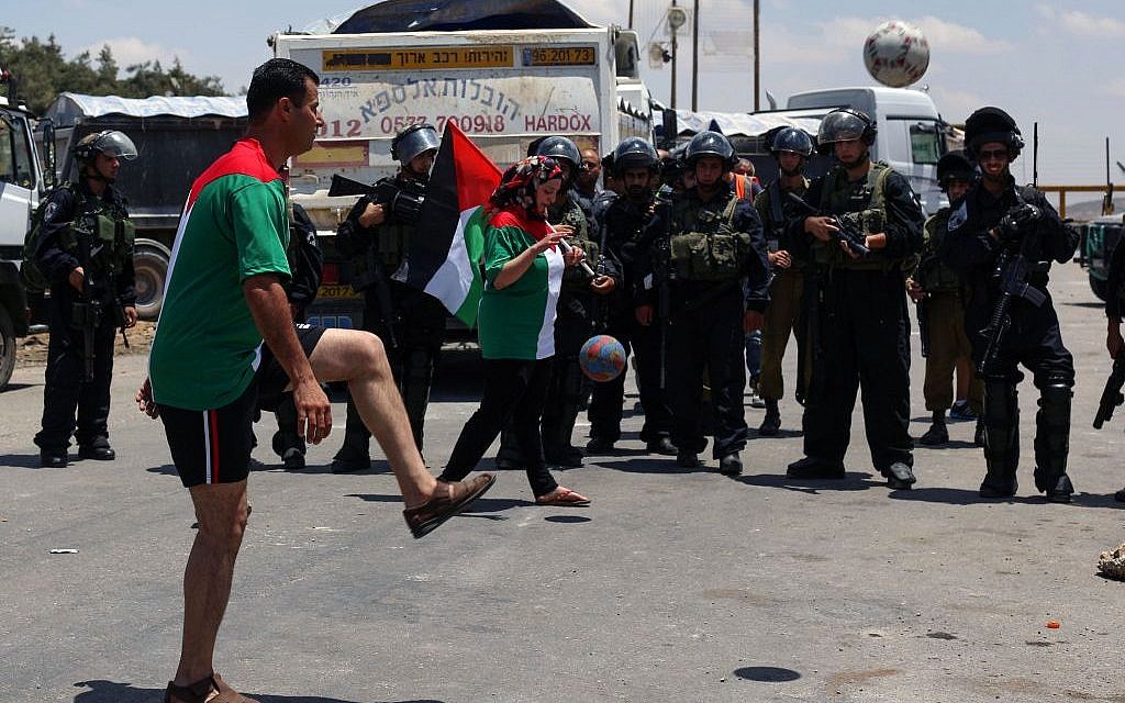 Illustrative photo of Palestinians playing soccer while rallying for hunger-striking prisoners outside Ofer Prison in the West Bank, on June 11, 2014. (Issam Rimawi/Flash90) Illustrative photo of Palestinians playing soccer while rallying for hunger-striking prisoners outside Ofer Prison in the West Bank, on June 11, 2014. (Issam Rimawi/Flash90)
