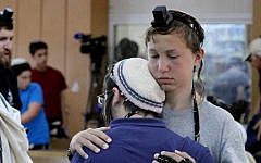 Students at the Mekor Haim Yeshiva comfort each other during a prayer session Sunday for three kidnapped teens. (Photo credit: Gershon Elinson/FLASH90)