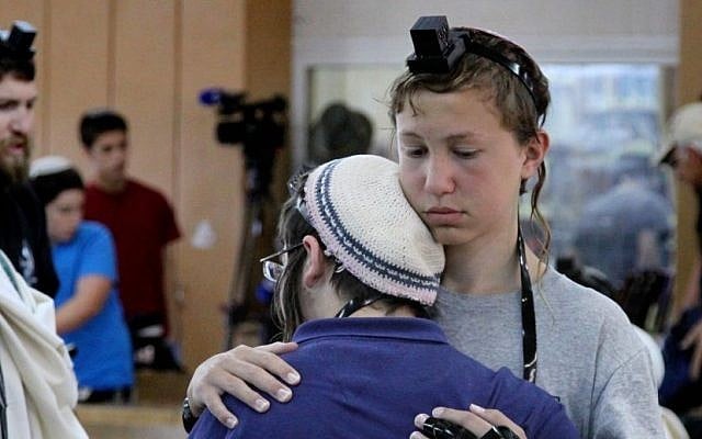 Students at the Mekor Haim Yeshiva comfort each other during a prayer session Sunday for three kidnapped teens. (Photo credit: Gershon Elinson/FLASH90) Students at the Mekor Haim Yeshiva comfort each other during a prayer session Sunday for three kidnapped teens. (Photo credit: Gershon Elinson/FLASH90)