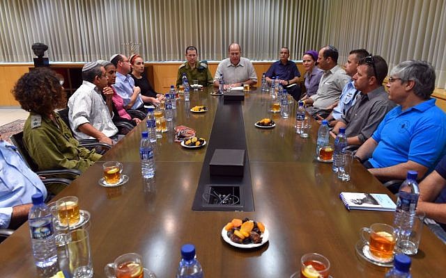 Defense Minister Moshe Ya'alon meets with the families of kidnapped Jewish teens Naftali Frankel, Gil-ad Shaar, and Eyal Yifrach, in Tel Aviv on Wednesday, June 18, 2014. (photo credit: Ariel Hermoni/Defense Ministry/Flash90)