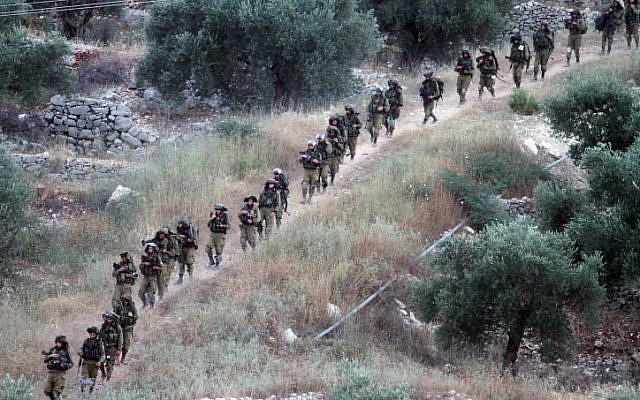 Israeli soldiers patrol the West Bank village of Aroura near Ramallah, early on June 20, 2014. (photo credit: Issam Rimawi/Flash 90) Israeli soldiers patrol the West Bank village of Aroura near Ramallah, early on June 20, 2014. (photo credit: Issam Rimawi/Flash 90)