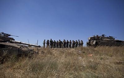 Israeli soldiers seen during patrol in the Golan Heights after a 15-year-old Israeli boy was killed in what the IDF said was a missile attack from Syria, June 22, 2014. (photo credit: Flash90)