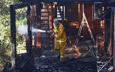 A firefighter seen trying to extinguish a large fire raging near Jerusalem’s Ein Kerem neighborhood on June 25, 2014. (Photo credit: Yonatan Sindel/FLASH90)