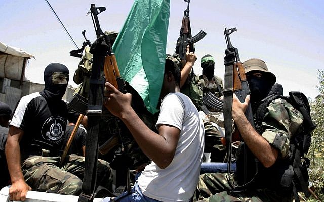 Palestinian militants of the Ezzedine al-Qassam Brigades, Hamas' armed wing, attend the funeral of militant Mohammed Obied during his funeral in the town of Deir al-Balah, in the central Gaza Strip on June 30, 2014 (photo credit: Abed Rahim Khatib/Flash90)