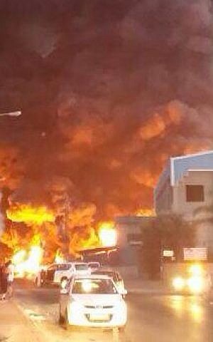 A rocket fired from Gaza directly hit a factory in the industrial zone of the southern Israeli city of Sderot, causing it to catch on fire, Saturday evening, June 28, 2014. The fire led to further explosions inside the factory. (Photo credit: Edit Israel/Flash90)