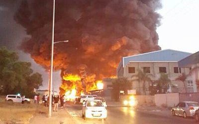 A rocket fired from Gaza directly hit a factory in the industrial zone of the southern Israeli city of Sderot, causing it to catch on fire, Saturday evening, June 28, 2014. The fire led to further explosions inside the factory. (Photo credit: Edit Israel/Flash90)
