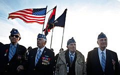 From left, World War II veterans of the U.S. 29th Infantry Division, Hal Baumgarter, 90 from Pennsylvania, Steve Melnikoff, 94, from Rhode Island, Don McCarthy, 90 from Maryland, and Morley Piper, 90, from Massachusetts, attend a D-Day commemoration, on Omaha Beach, western France , Friday June 6, 2014. (photo credit: AP/Thibault Camus)