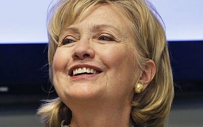 Hillary Clinton smiles during a meeting with community leaders following a tour at Intertech Plastics in Denver, Monday, June 2, 2014. (photo credit: AP/Brennan Linsley)