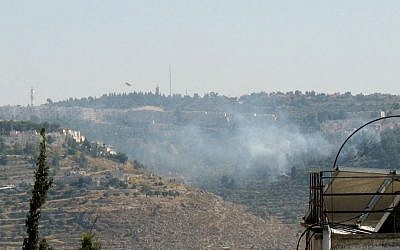 Two firefighting planes making repeated runs over a large blaze in a forest in southern Jerusalem. (photo credit: Times of Israel/Stuart Winer)
