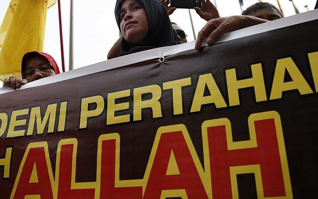 A Muslim woman holds a banner reading "Allah" during a protest outside the Court of Appeal in Putrajaya, outside Kuala Lumpur, Malaysia, Monday, June 23, 2014. (AP Photo/Vincent Thian) A Muslim woman holds a banner reading "Allah" during a protest outside the Court of Appeal in Putrajaya, outside Kuala Lumpur, Malaysia, Monday, June 23, 2014. (AP Photo/Vincent Thian)