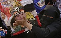 A supporter of Abdel-Fattah el-Sissi, the nation’s former military chief, hugs his poster during a celebration at Tahrir Square in Cairo, Egypt, Tuesday, June 3, 2014. (photo credit: AP/Amr Nabil)