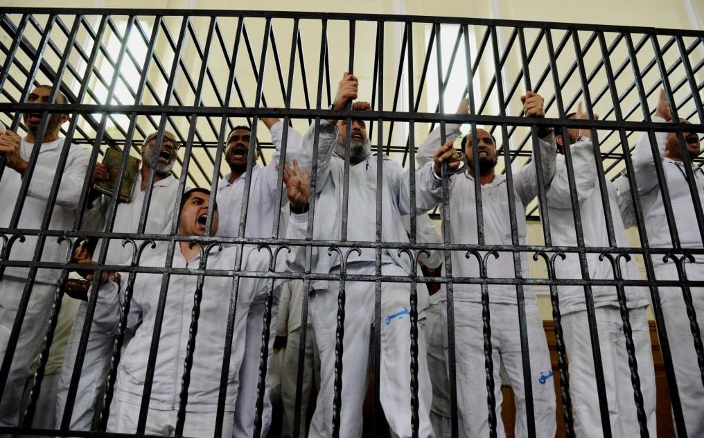 Supporters of Egypt's ousted president Mohammed Morsi charged with violence chant slogans against the Egyptian military during a trial in Alexandria, Egypt, on Saturday, March 29, 2014. (photo credit: AP/Heba Khamis/File) Supporters of Egypt's ousted president Mohammed Morsi charged with violence chant slogans against the Egyptian military during a trial in Alexandria, Egypt, on Saturday, March 29, 2014. (photo credit: AP/Heba Khamis/File)
