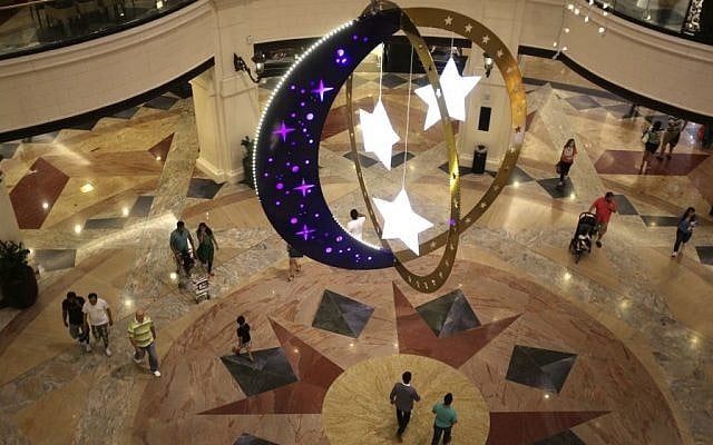 People walk inside a shopping mall with Ramadan decorations as they prepare for the holy month of Ramadan starting tomorrow in Dubai, United Arab Emirates, Saturday, June 28, 2014. (photo credit: AP /Kamran Jebreili)