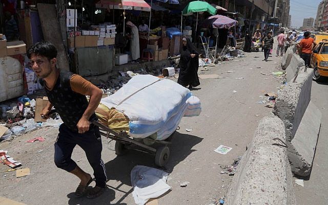 In this photo taken on June 17, 2014, people shop around at a market in Baghdad, Iraq. (photo credit: AP Photo/Karim Kadim) In this photo taken on June 17, 2014, people shop around at a market in Baghdad, Iraq. (photo credit: AP Photo/Karim Kadim)