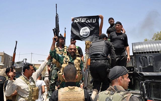 Iraqi security forces hold up a flag of the Islamic State in Iraq and the Levant they captured during an operation to regain control of Dallah Abbas north of Baqouba, 35 miles (60 kilometers) northeast of Baghdad, Iraq, June 28, 2014. (photo credit: AP) Iraqi security forces hold up a flag of the Islamic State in Iraq and the Levant they captured during an operation to regain control of Dallah Abbas north of Baqouba, 35 miles (60 kilometers) northeast of Baghdad, Iraq, June 28, 2014. (photo credit: AP)