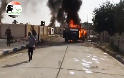 This image made from video posted by Iraqi0Revolution, a group supporting the al-Qaeda breakaway Islamic State of Iraq and the Levant (ISIL) on Wednesday, June 11, 2014, shows an attack on a base north of Tikrit, Iraq. (photo credit: AP Photo/Iraqi0Revolution via AP video)