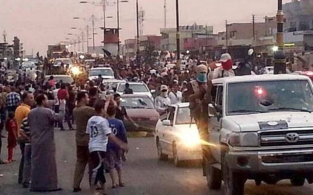 Militants parade down a main road in Mosul, Iraq, on Wednesday, June 11, 2014. (photo credit: AP/militant source via Twitter) Militants parade down a main road in Mosul, Iraq, on Wednesday, June 11, 2014. (photo credit: AP/militant source via Twitter)