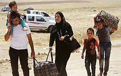 Iraqis who have fled the violence in their hometown of Mosul line arrive at Khazir refugee camp outside of Irbil, 217 miles (350 kilometers) north of Baghdad, Iraq, Monday, June 16, 2014. (AP Photo)