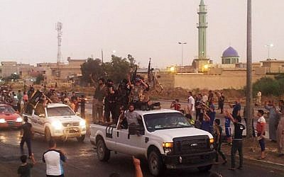 Islamic State fighters parade in the northern city of Mosul, Iraq, on ,June 25, 2014 (photo credit: AP) 