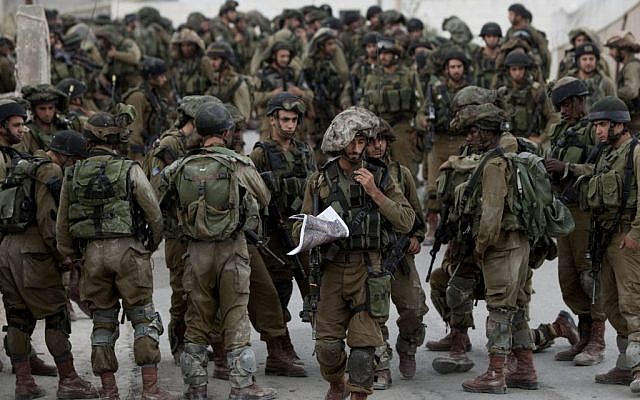 Israeli soldiers patrol in the village of Beit Kahil near the West Bank city of Hebron on June 21, 2014. (AP/Majdi Mohammed) Israeli soldiers patrol in the village of Beit Kahil near the West Bank city of Hebron on June 21, 2014. (AP/Majdi Mohammed)