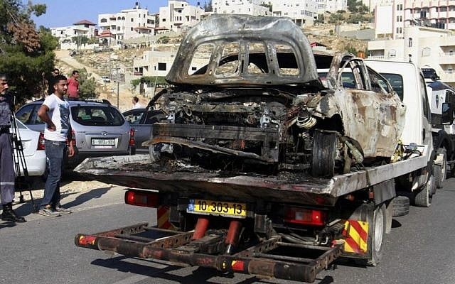 A burnt car which may be connected to the disappearance of three Israeli teenagers in the West Bank is taken away near Hebron, Friday, June 13, 2014. (Photo credit: AP/Nasser Shiyoukhi) A burnt car which may be connected to the disappearance of three Israeli teenagers in the West Bank is taken away near Hebron, Friday, June 13, 2014. (Photo credit: AP/Nasser Shiyoukhi)