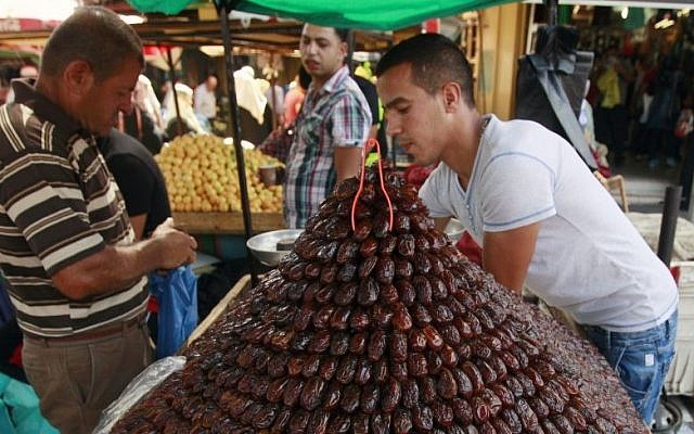 A Palestinian vendor sells dates for Ramadan at a market in Jenin, June 28, 2014. (photo credit: AP/Mohammed Ballas) A Palestinian vendor sells dates for Ramadan at a market in Jenin, June 28, 2014. (photo credit: AP/Mohammed Ballas)