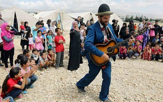 In this June 6, 2014 photo, American clown David Clay, a member of "Clowns Without Borders," performs for children at a Syrian refugee camp in the eastern town of Chtoura, in Bekaa valley, Lebanon. (AP Photo/Bilal Hussein) In this June 6, 2014 photo, American clown David Clay, a member of "Clowns Without Borders," performs for children at a Syrian refugee camp in the eastern town of Chtoura, in Bekaa valley, Lebanon. (AP Photo/Bilal Hussein)