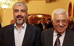 In this file photo provided on Nov. 24, 2011, by the office of Khaled Mashaal, Hamas leader Mashaal, left, and Palestinian Authority President Mahmoud Abbas are seen together during a meeting in Cairo, Egypt. (photo credit: AP/Office of Khaled Meshaal)