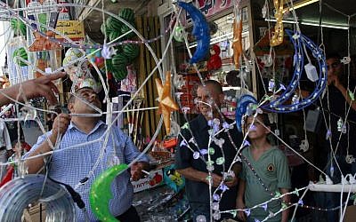 Illustrative: A Palestinian vendor displays decorations at a market ahead of Ramadan in the West Bank city of Jenin, June 28, 2014. (AP/Mohammed Ballas)
