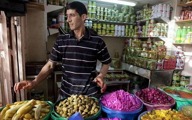 A Palestinian vendor displays food, including pickled vegetables and olives, in preparation for Ramadan at a market in the West Bank city of Hebron,, June 28, 2014. (AP/Majdi Mohammed) A Palestinian vendor displays food, including pickled vegetables and olives, in preparation for Ramadan at a market in the West Bank city of Hebron,, June 28, 2014. (AP/Majdi Mohammed)