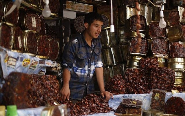 A Yemeni vendor displays a variety of dates, traditionally eaten after breaking the fast, on the first day of the Muslim holy month of Ramadan in a market in the Old City of Sanaa, Yemen, Saturday, June 28, 2014. (photo credit: AP/Hani Mohammed)