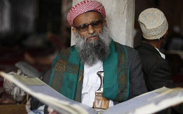 An elderly man reads verses of the Quran, Islam's holy book, on the first day of the holy month of Ramadan in the Grand Mosque in the Old City of Sanaa, Yemen, Saturday, June 28, 2014. (photo credit: AP/Hani Mohammed)