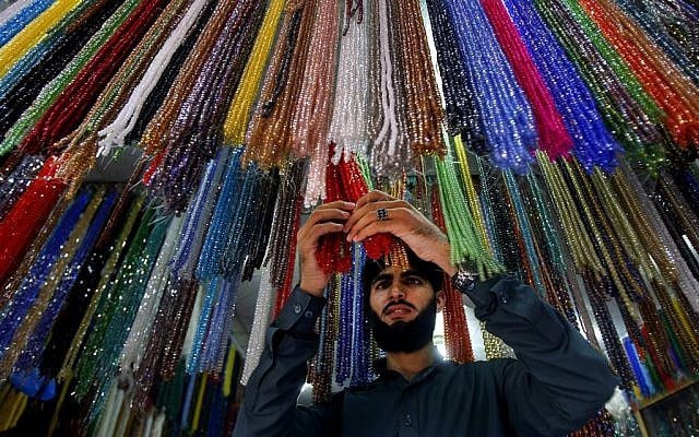 A Pakistani vendor arranges praying beads which worshippers buy for Islamic holy month of Ramadan in Peshawar, Pakistan, Saturday, July 28, 2014. (photo credit: AP/Mohammad Sajjad)