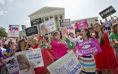 Demonstrators react to hearing the Supreme Court's decision on the Hobby Lobby case outside the Supreme Court in Washington, Monday, June 30, 2014. (photo credit: AP Photo/Pablo Martinez Monsivais)