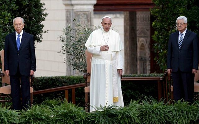 Pope Francis, center, flanked by Israel's President Shimon Peres, left, and Palestinian Authority President Mahmoud Abbas, left, pray for peace in the Vatican gardens, Sunday, June 8, 2014. (AP Photo/Gregorio Borgia)