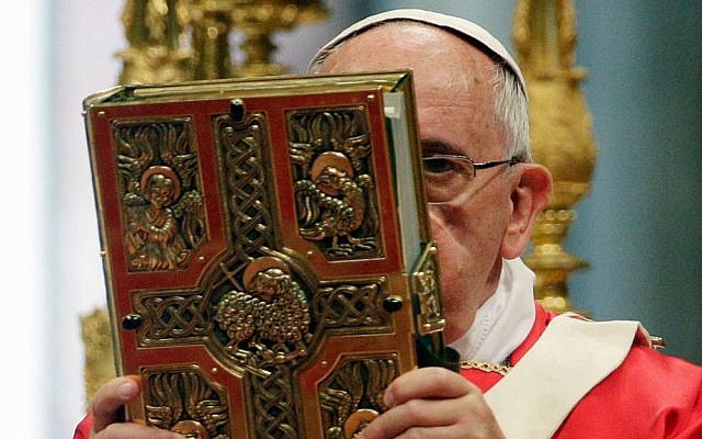 Pope Francis holds the book of the gospels as he celebrates a mass of Pentecost in St. Peter's Basilica, at the Vatican, Sunday, June 8, 2014. (AP/Gregorio Borgia)