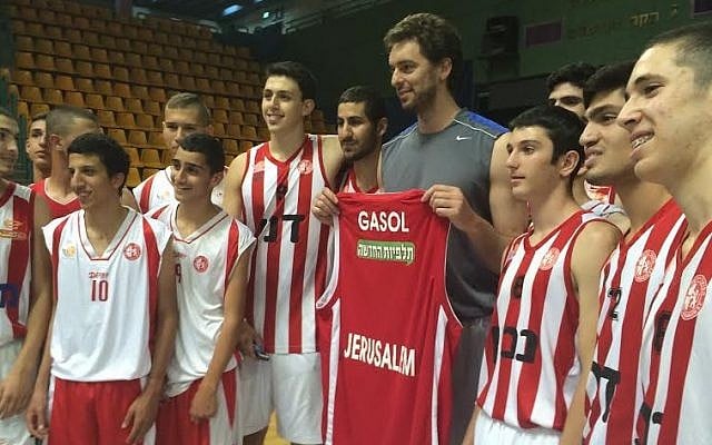 Pau Gasol holds up his new shirt at his Jerusalem basketball clinic, June 1, 2014 (photo credit- Raphael Gellar) Pau Gasol holds up his new shirt at his Jerusalem basketball clinic, June 1, 2014 (photo credit- Raphael Gellar)