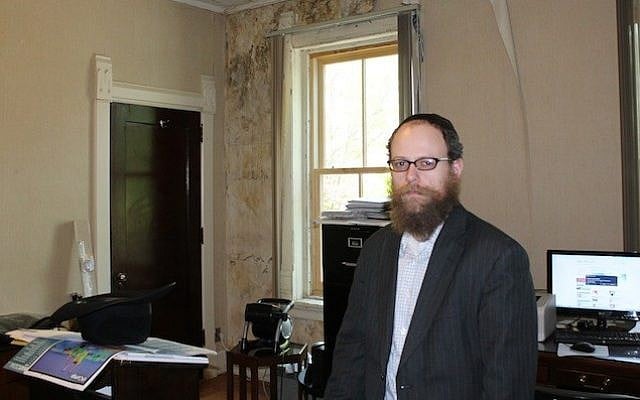 Rabbi Uri Perlman, founder of the Bais Menachem Youth Development program, runs the yeshiva out of a rundown building that used to be a real estate office. (photo credit: Uriel Heilman/JTA)