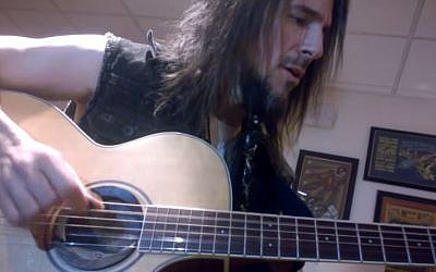Guns N’ Roses lead guitarist Ron 'Bumblefoot' Thal plays the Israeli national anthem, 'Hatikva,' backstage before a concert in Las Vegas in June 2014. (screen capture, YouTube)
