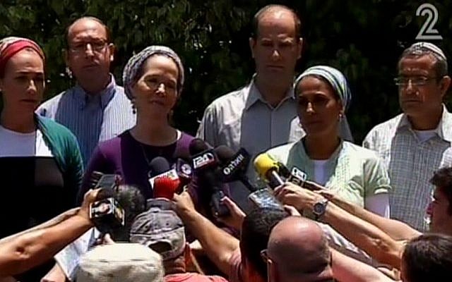 Racheli Sprecher Frankel, mother of kidnapped Israeli youth Naftali, speaks to the press outside her house on Tuesday, June 16, 2014. She is flanked by the parents of two other teens kidnapped with her son, Gil-ad Shaar and Eyal Yifrach. (screen capture: Channel 2)