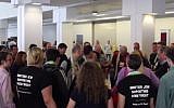 Several attendants of the Presbyterian General Assembly in Detroit form a prayer circle and sing for Israeli-Arab peace. Two are seen wearing shirts which read: 'Another Jew supporting divestment.' (screen capture: YouTube)