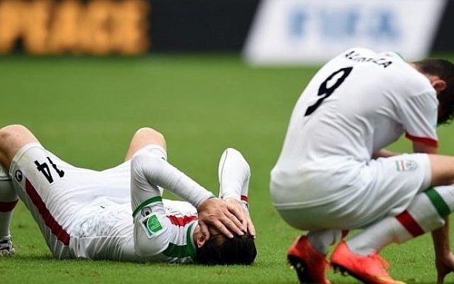 Iran's midfielder Andranik Teymourian (L) and Iran's forward Alireza Jahanbakhsh react after their team lost a Group F football match between Bosnia-Hercegovina and Iran at the Fonte Nova Arena in Salvador during the 2014 FIFA World Cup on June 25, 2014. Bosnia-Hercegovina won 3-1. (photo credit: AFP PHOTO / JAVIER SORIANO) Iran's midfielder Andranik Teymourian (L) and Iran's forward Alireza Jahanbakhsh react after their team lost a Group F football match between Bosnia-Hercegovina and Iran at the Fonte Nova Arena in Salvador during the 2014 FIFA World Cup on June 25, 2014. Bosnia-Hercegovina won 3-1. (photo credit: AFP PHOTO / JAVIER SORIANO)